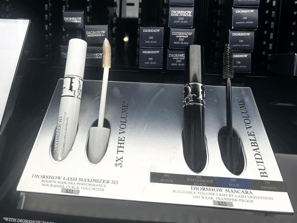 Diorshow lash maximizer and mascara on display. The lash maximizer comes in a white tube, and the mascara comes in a black tube.