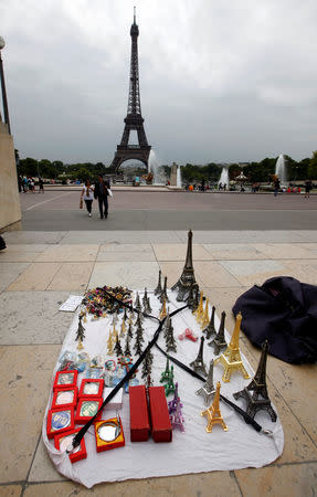 FILE PHOTO: Eiffel tower models are displayed for tourists by a souvenir vendor in front the Eiffel Tower at the Trocadero in Paris, France, July 26, 2011. REUTERS/Eric Gaillard/File Photo