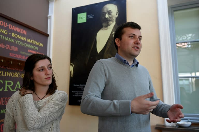 A portrait of Esperanto creator Ludwik Zamenhof looks over Przemyslaw Wierzbowski, Esperanto association president in Bialystok and French student Amelie Chartier, who volunteers at a body to promote the synthetic language