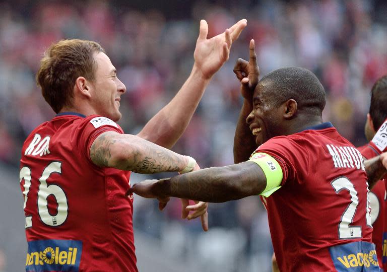 Lille's French forward Nolan Roux (L) celebrates after scoring during the French Ligue 1 match against Bordeaux at the Pierre Mauroy Stadium in Villeneuve d'Ascq, northern France, on April 19, 2015