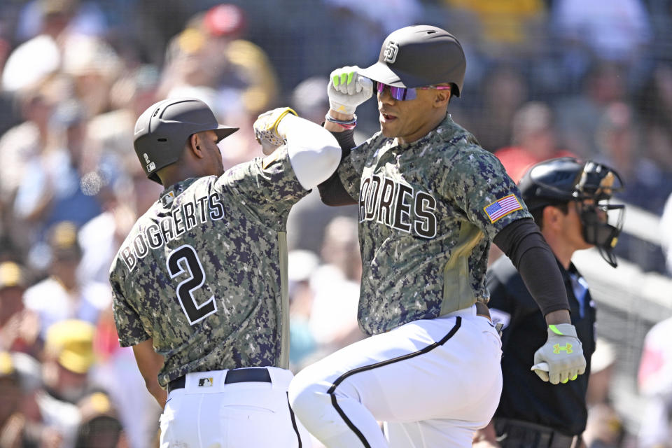 San Diego Padres' Juan Soto, front right, is congratulated by Xander Bogaerts (2) after hitting a three-run home run during the first inning of a baseball game against the St. Louis Cardinals, Sunday, Sept. 24, 2023, in San Diego. (AP Photo/Denis Poroy)
