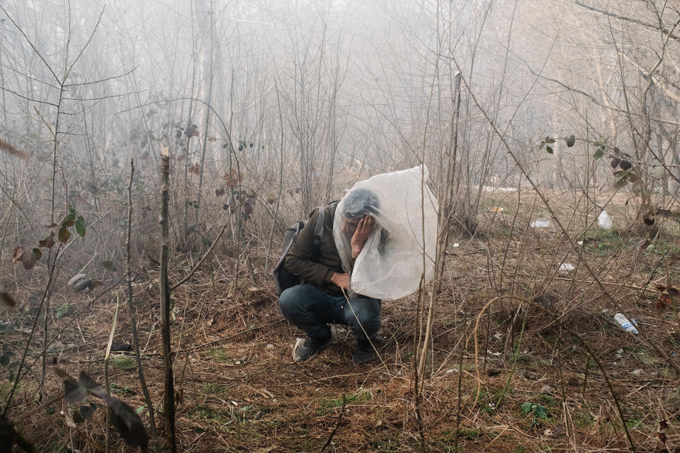 A man desperately tries to protect himself in Edirne, Turkey, from tear gas launched by Greek authorities at the border in March.<span class="copyright">Emin Ozmen—Magnum Photos for TIME</span>