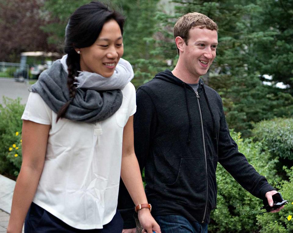 Mark Zuckerberg walks with his wife Priscilla Chan while arriving for a morning session during the Allen & Co. Media and Technology Conference in Sun Valley, Idaho, U.S., on Thursday, July 11, 2013