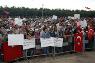 Thousands of people gather to protest COVID-19 precautions, in Istanbul, Saturday, Sept. 11, 2021. Unmasked crowds met in Maltepe, an open space on the city's Asian side, to call for an end to restrictions designed to combat the virus. Turkey has seen a rise in cases and deaths since it opened in July after a lockdown, with daily infections increasing from around 5,000 to more than 20,000.(AP Photo/Mehmet Guzel)