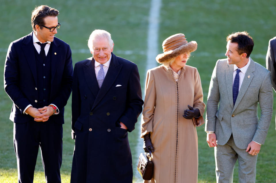 WREXHAM, UNITED KINGDOM - DECEMBER 09: (EMBARGOED FOR PUBLICATION IN UK NEWSPAPERS UNTIL 24 HOURS AFTER CREATE DATE AND TIME) Co-owners of Wrexham AFC Ryan Reynolds (L) and Rob McElhenney (R) meet King Charles III and Camilla, Queen Consort as they visit Wrexham Association Football Club on December 9, 2022 in Wrexham, Wales. Formed in 1864 Wrexham AFC is the oldest club in Wales and the third oldest professional team in the world. The club was taken over by Hollywood actors Ryan Reynolds and Rob McElhenney in late 2020. (Photo by Max Mumby/Indigo/Getty Images)