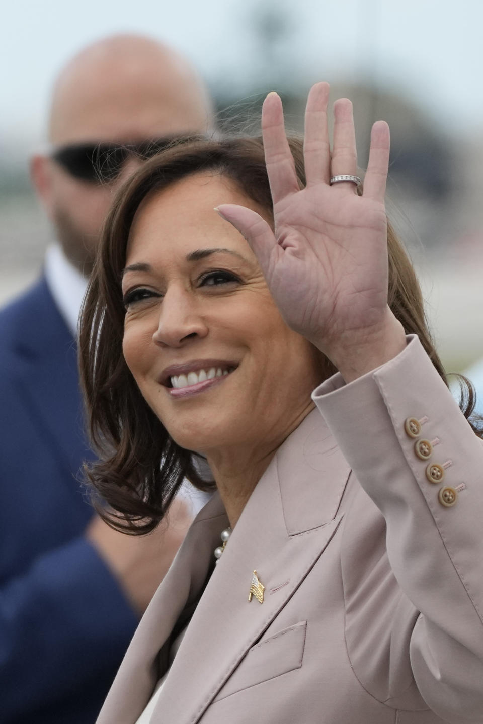 Vice President Kamala Harris waves as she arrives at Miami International Airport, Friday, April 21, 2023, in Miami. Harris traveled to Miami on Friday to announce funding for climate change resiliency projects across the U.S. (AP Photo/Rebecca Blackwell)