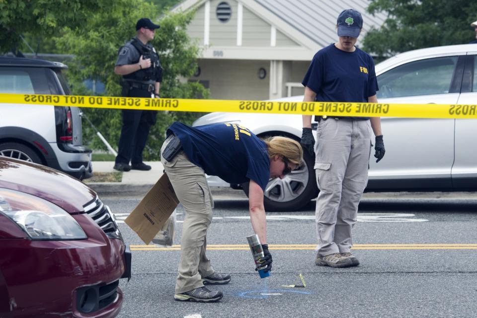 <p>FBI Evidence Response Team members mark evidence at the scene of a multiple shooting in Alexandria, Va., Wednesday, June 14, 2017, where House Majority Whip Steve Scalise of La., and others, were shot at a congressional baseball practice. (Photo: Cliff Owen/AP) </p>