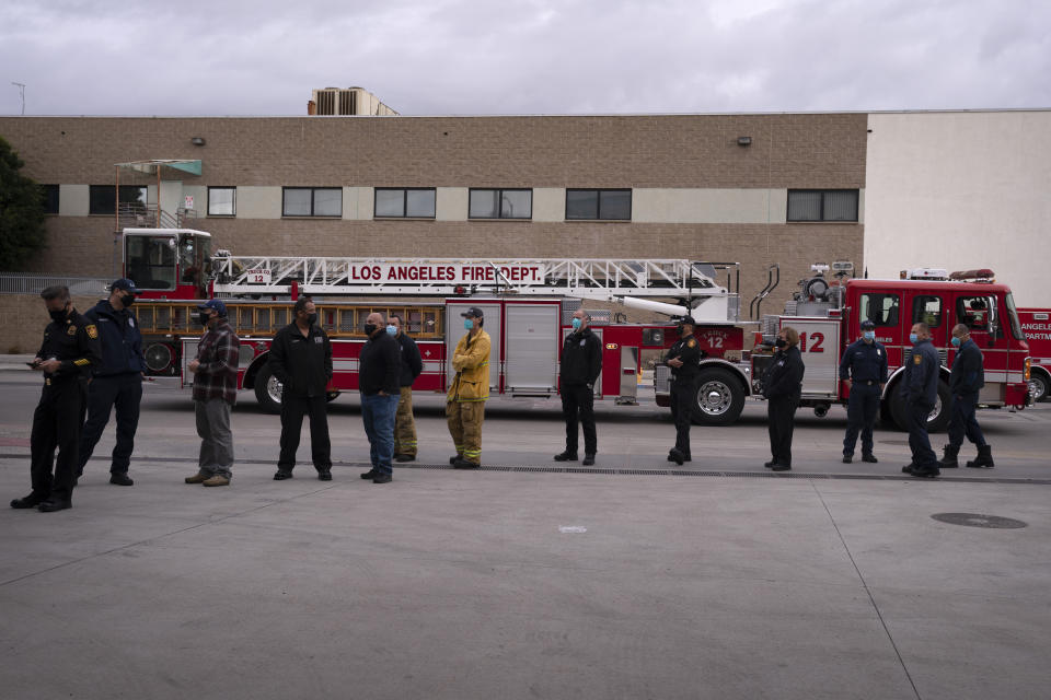 Firefighters wait in line to get their COVID-19 vaccine at a fire station in Los Angeles, Wednesday, Jan. 27, 2021. (AP Photo/Jae C. Hong)