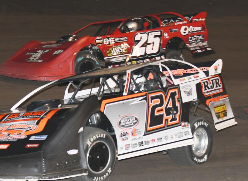 Ryan Unzicker (24) leads Shane Clanton in late model action Saturday at Fairbury Speedway.