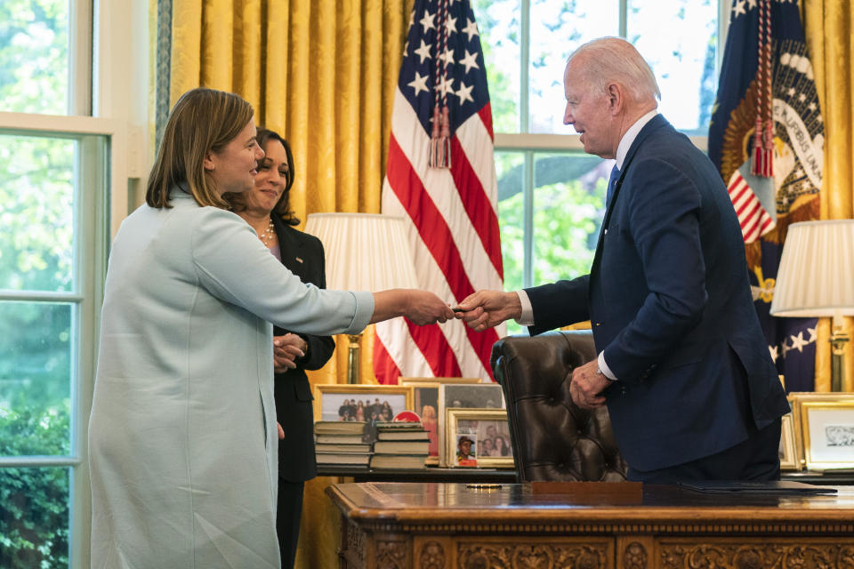 FILE - President Joe Biden hands one of the pens he used for singing the Ukraine Democracy Defense Lend-Lease Act of 2022 to Rep. Elissa Slotkin, D-Mich., left, during a ceremony in the Oval Office of the White House, Monday, May 9, 2022, in Washington, as Vice President Kamala Harris looks on. Slotkin will seek an open U.S. Senate seat being vacated by Democrat Debbie Stabenow in 2024, becoming the first high-profile candidate to jump into the battleground state race. (AP Photo/Manuel Balce Ceneta, File)