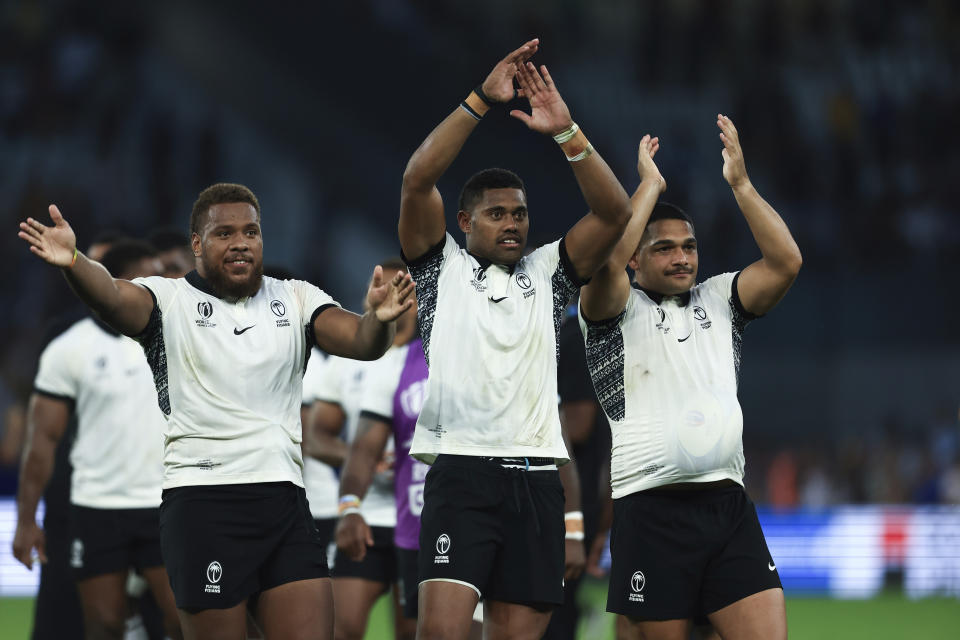 Fiji's players celebrate after the Rugby World Cup Pool C match between Australia and Fiji at the Stade Geoffroy Guichard in Saint-Etienne, France, Sunday, Sept. 17, 2023. (AP Photo/Aurelien Morissard)