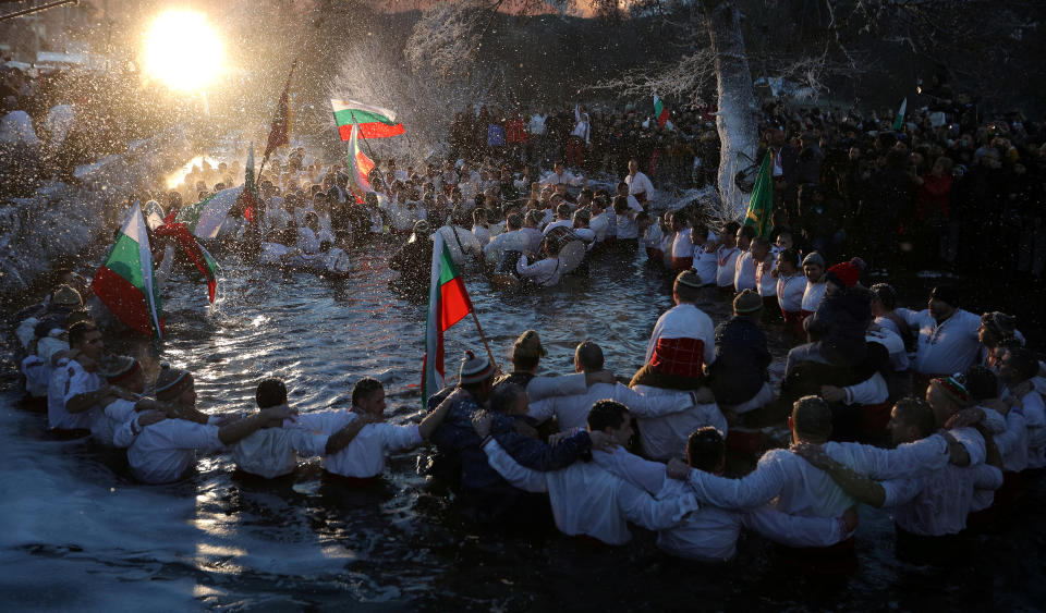 <p>Bulgarian men dance in the waters of the Tundzha river during a celebration to commemorate Epiphany Day in the town of Kalofer, Bulgaria, Jan. 6, 2018. (Photo: Stoyan Nenov/Reuters) </p>