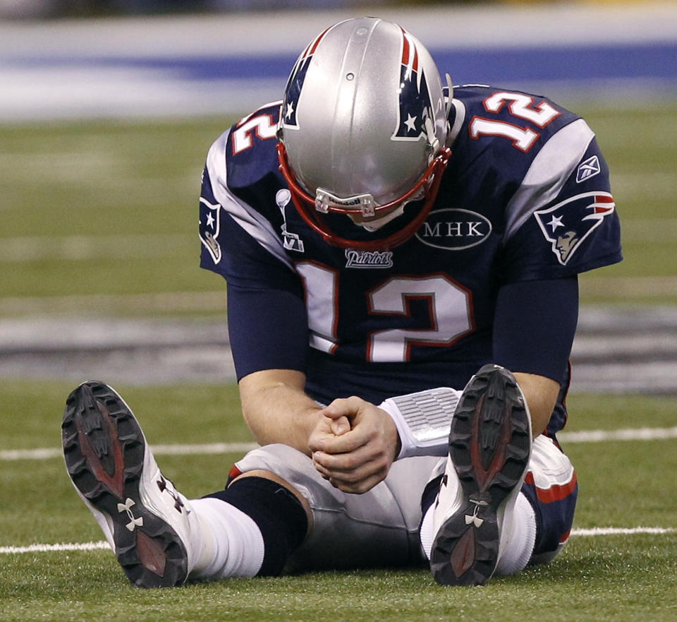 FILE - In this Feb. 5, 2012, file photo, New England Patriots quarterback Tom Brady reacts after New York Giants linebacker Chase Blackburn intercepted Brady's pass intended for tight end Rob Gronkowski during the second half of the NFL Super Bowl XLVI football game in Indianapolis. Brady’s journey to each of his nine Super Bowls with the New England Patriots will be the subject of an ESPN series released in 2021. Entitled “The Man in the Arena: Tom Brady,” the nine-episode series will include a look from Brady’s perspective at the six NFL titles and three Super Bowl defeats he was a part of. (AP Photo/Paul Sancya, File)