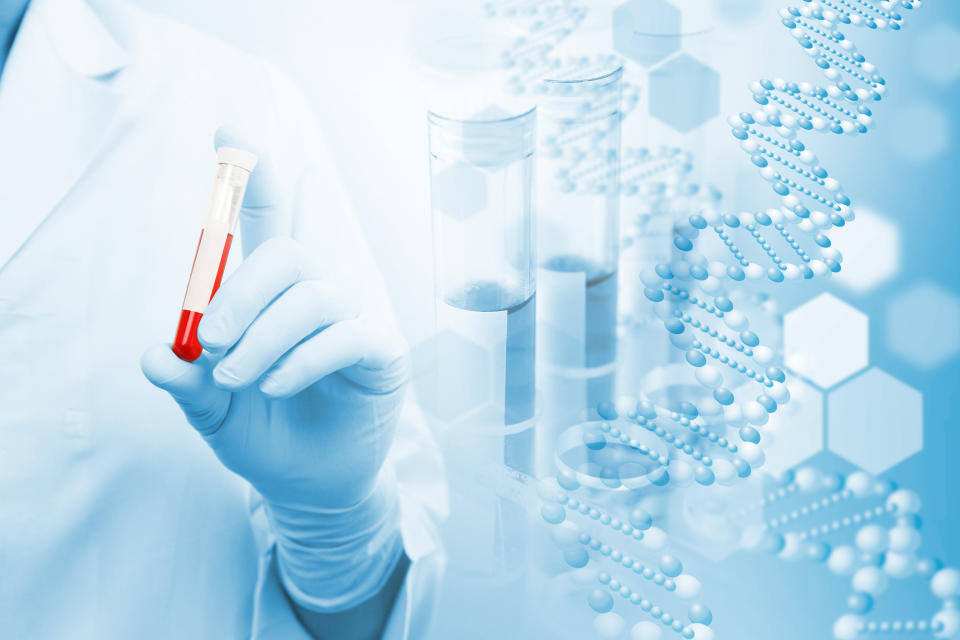 Person in a white coat holding a vial of blood with images of test tubes and DNA in the background