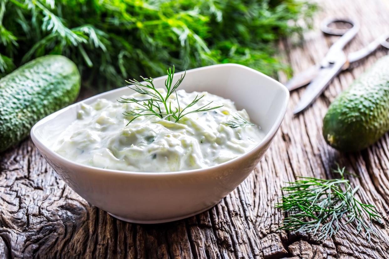 Tzatziki. Traditional greek dip sauce or dressing tzatziki prepared with grated cucumber sour cream yogurt olive oil and fresh dill. Mediterrannan cuisine