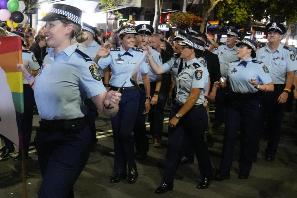 The New South Wales Police Commissioner Karen Webb, second left, waves as she marches in the 45th Anniversary Sydney Gay and Lesbian Mardi Gras Parade in Oxford Street, Sydney, Australia, Saturday, Feb. 25, 2023. Organizers of the Sydney Gay and Lesbian Mardi Gras have asked police not to march at their annual parade at the weekend due to an alleged murder of a couple by a police officer, prompting the police commissioner on Tuesday, Feb, 27, 2024, to urge the ban be reversed. (AP Photo/Mark Baker)