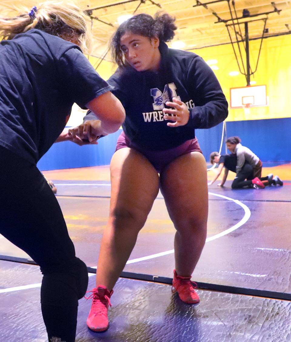 Mainland wrestler Cheyenne Wigley trains with teammate Eva Rojas during practice, Tuesday, Feb. 13, 2024, at Mainland High School.