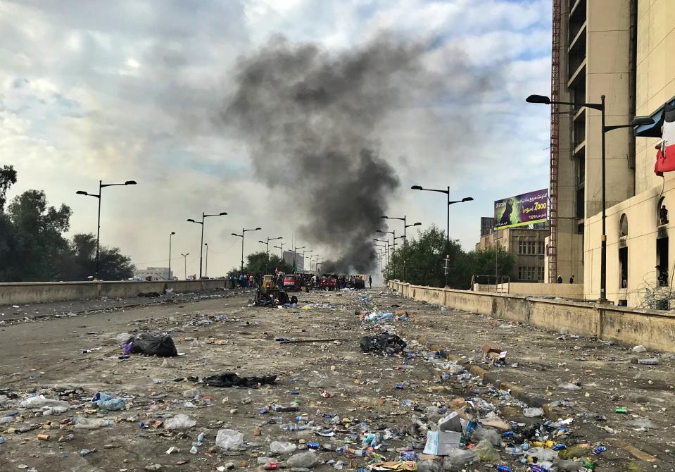 Anti-government protesters light fires while Iraqi security forces close the bridge leading to the Green Zone during a demonstration in Baghdad, Iraq, Tuesday, Oct. 29, 2019. (AP Photo/Ali Abdul Hassan)