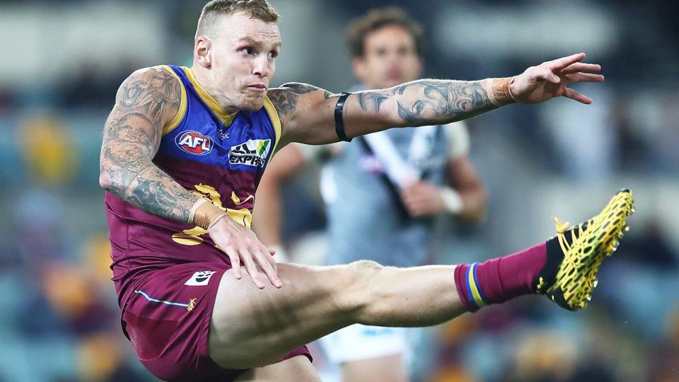 Seen here, Mitch Robinson kicks a ball for the Brisbane Lions in the AFL. 