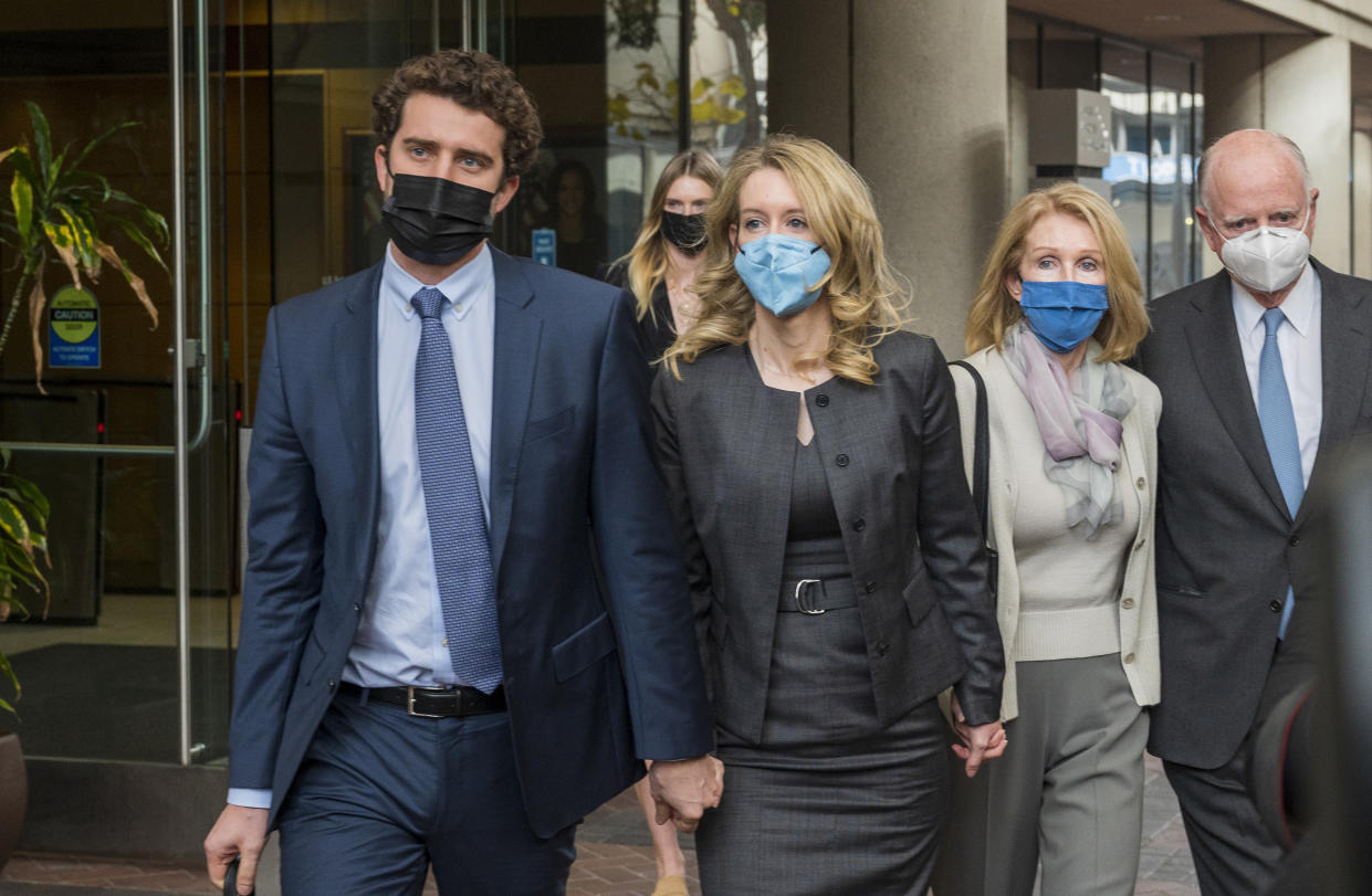 Elizabeth Holmes, center, leaves federal court in San Jose, Calif., Monday, Jan. 3, 2022. (AP Photo/Nic Coury)