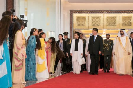 Prime Minister and Vice-President of the United Arab Emirates and ruler of Dubai Sheikh Mohammed bin Rashid al-Maktoum (R) receives Chinese President Xi Jinping in Abu Dhabi, United Arab Emirates July 19, 2018. WAM/Handout via Reuters