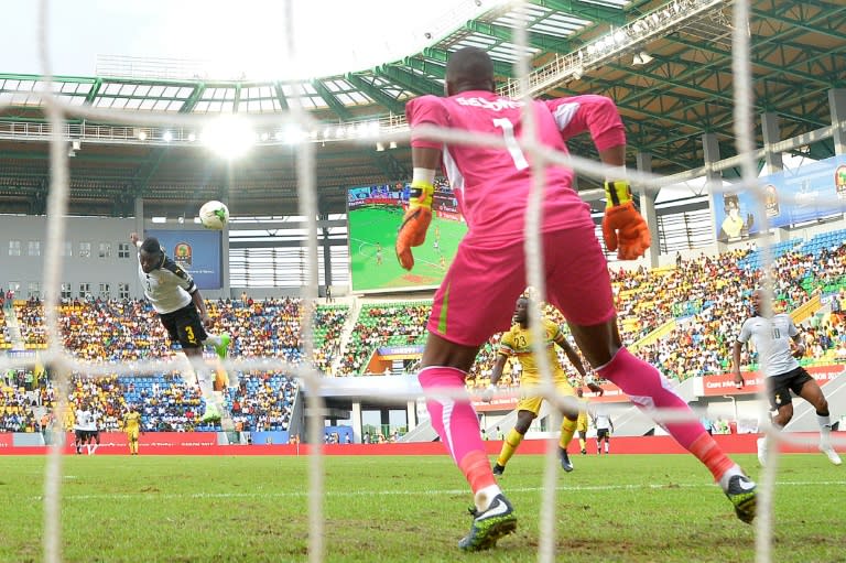 Ghana's Asamoah Gyan (L) scores a header during their 2017 Africa Cup of Nations Group D against Mali, in Port-Gentil, on January 21, 2017