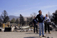 California Gov. Gavin Newsom, left, and Nevada Gov. Steve Sisolak speak after touring homes destroyed by wildfires near where the Tamarack Fire ignited earlier in July in Gardnerville, Nev., Wednesday, July 28, 2021. Nevada Gov. Steve Sisolak and California Gov. Gavin Newsom stood on ashen ground as they surveyed burned homes and a mountain range of pine trees charred by the Tamarack Fire south of Gardnerville, Nevada, near Topaz Lake. The governors, both Democrats, called on the federal government to provide more firefighting resources and stressed that climate change could make wildfires even more intense and destructive in the future. (AP Photo/Sam Metz)