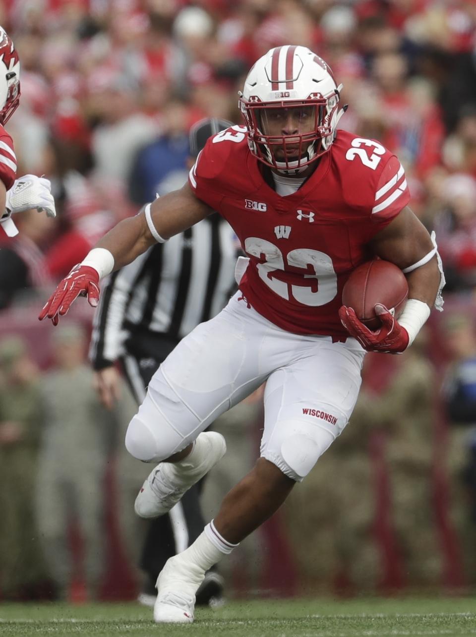 FILE - In this Nov. 3, 2018, file photo, Wisconsin's Jonathan Taylor runs during the first half against Rutgers, in Madison, Wis. Taylor was named to the 2018 AP All-America NCAA college football team, Monday, Dec. 10, 2018. (AP Photo/Morry Gash, File)