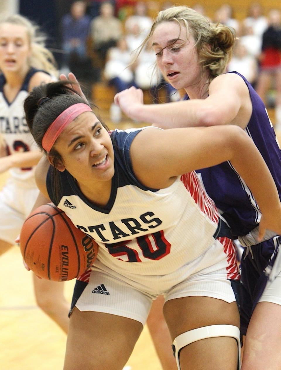 BNL's Emma Crane wrestles a rebound away from Bloomington South's Abbie Lucas.