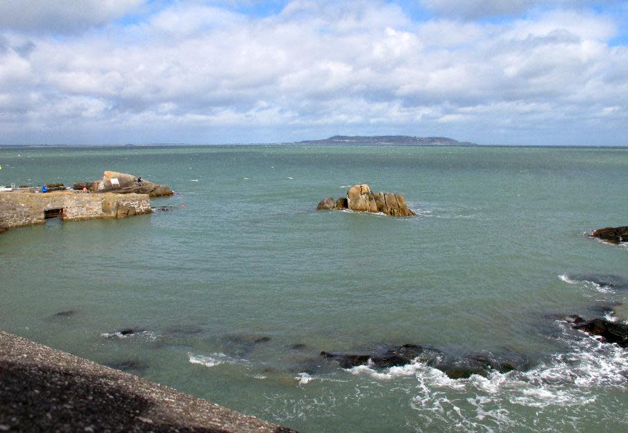 This March 17, 2014 photo shows the view across Dublin Bay from the stone tower featured in the opening scene of Ulysses, which is now a James Joyce museum in Dublin, Ireland. In the novel Joyce describes "warm sunshine merrying over the sea". Every June 16 _ Bloomsday_ Joyce lovers gather here to read passages from Ulysses and take a dip in the nearby once-famous gentlemen-only bathing spot known as the "forty foot." (AP Photo/Helen O'Neill)