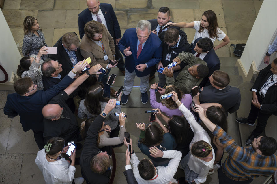 Speaker of the House Kevin McCarthy, R-Calif., is surrounded by reporters looking for updates on plans to fund the government and avert a shutdown, at the Capitol in Washington, Friday, Sept. 22, 2023. (AP Photo/J. Scott Applewhite)