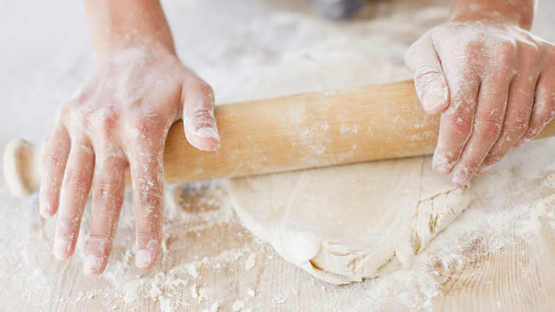 someone using a rolling pin