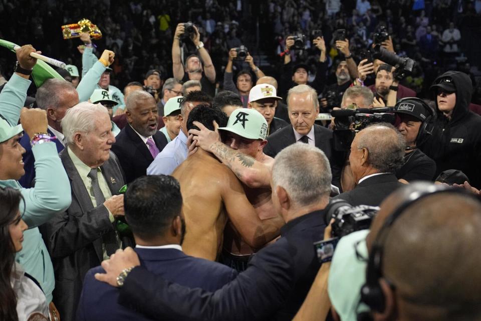 Canelo Alvarez, center right, embraces Jaime M