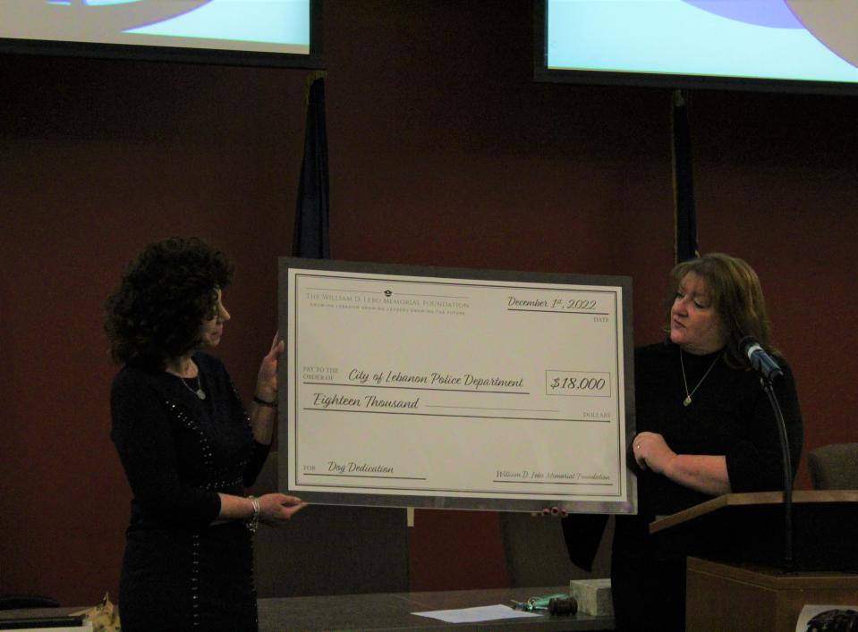 Lora Lebo (right) presented a check in the amount of $18,000 to the City of Lebanon to acquire a new K-9 unit.