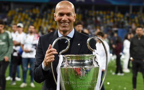 Real Madrid's French coach Zinedine Zidane holds the trophy as he celebrates winning the UEFA Champions League final football match between Liverpool and Real Madrid - Credit: AFP PHOTO / FRANCK FIFE