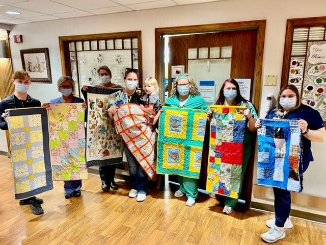 Pictured (left to right) are Jacob Coy, Serena Trafzer, Kim Porter (grandma), Kinzie Lantini (mom) with Cora, Holly Wilhelm, Alysia Stark and Hayleigh Anthony in front of the special care nursery at OhioHealth Marion General Hospital.