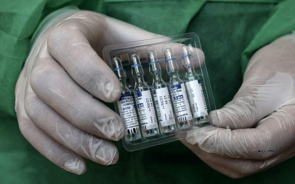(FILES) In this file photo taken on March 27, 2021 a health worker shows vials of the Russian Sputnik V vaccine, at a vaccination centre in Gaza City. - Germany's Bavaria region has signed a previsional agreement to buy doses of Russia's Sputnik V coronavirus vaccine once it is approved by European regulators, state premier Markus Soeder said on April 7, 2021. The southern state has "signed a memorandum of understanding today... for the supply of Sputnik," Soeder told reporters in Munich. (Photo by Mohammed ABED / AFP) (Photo by MOHAMMED ABED/AFP via Getty Images) - MOHAMMED ABED/AFP