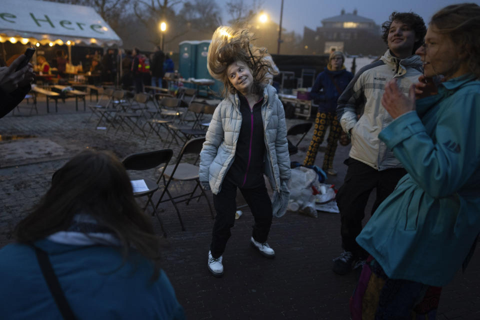 Climate activist Greta Thunberg dances after addressing tens of thousands of people who marched through Amsterdam, Netherlands, Sunday, Nov. 12, 2023, to call for more action to tackle climate change. Thunberg was among the speakers at the march that comes 10 days before national elections in the Netherlands. (AP Photo/Peter Dejong)