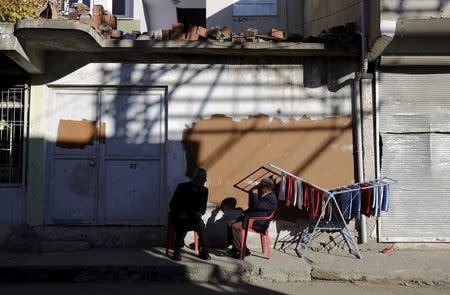 Men chat next to a barber shop in the southeastern town of Silvan in Diyarbakir province, Turkey, December 7, 2015. REUTERS/Murad Sezer