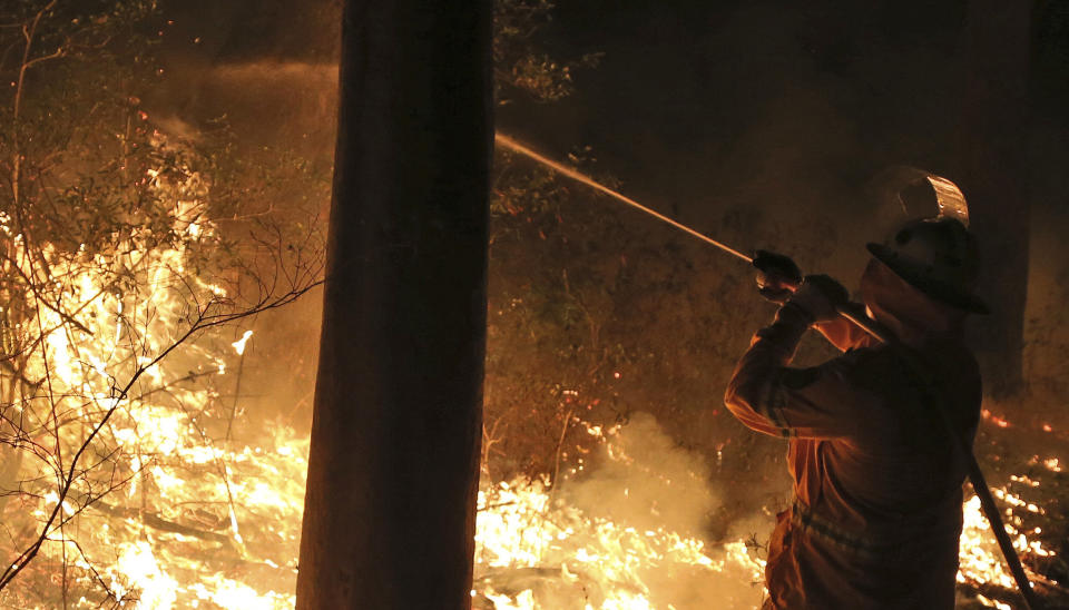 Firefighters control flames during hazard reduction in Bilpin 75 kilometers (46 miles) from Sydney in Australia, Wednesday, Oct. 23, 2013. (AP Photo/Rob Griffith)