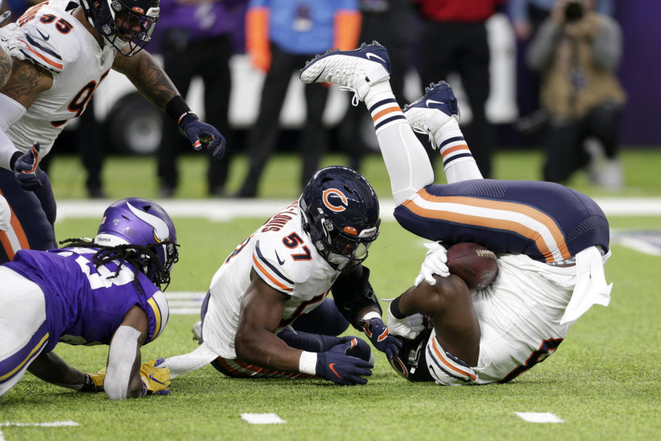 Chicago Bears defensive tackle Bilal Nichols, right, and linebacker Kevin Pierre-Louis (57) recover a fumble by Minnesota Vikings running back Mike Boone, left, during the first half of an NFL football game, Sunday, Dec. 29, 2019, in Minneapolis. (AP Photo/Andy Clayton-King)