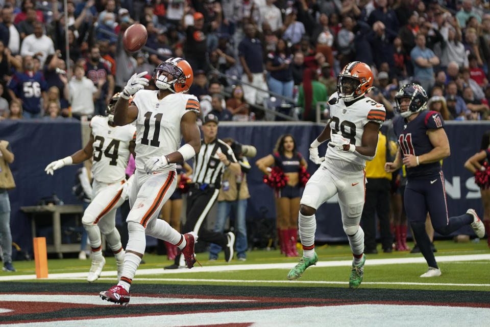 Cleveland Browns wide receiver Donovan Peoples-Jones (11) flips the ball in the air after scoring a touchdown on a 76-yard punt return during the first half of an NFL football game between the Cleveland Browns and Houston Texans in Houston, Sunday, Dec. 4, 2022,. (AP Photo/Eric Christian Smith)