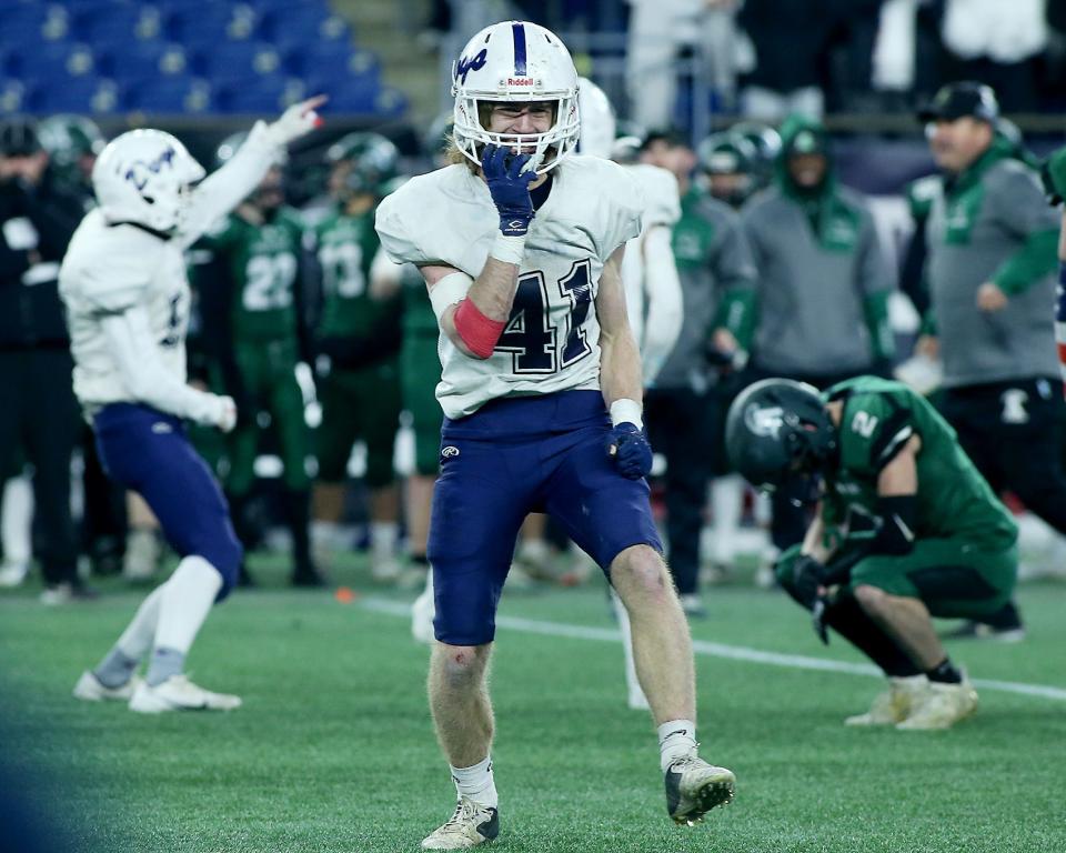Rockland’s Jacob Coulstring celebrates an Abington turnover as Abington’s Drew Donovan looks down dejectedly during the fourth quarter of the Division 6 state title game at Gillette Stadium in Foxboro on Friday, Dec. 3, 2021.