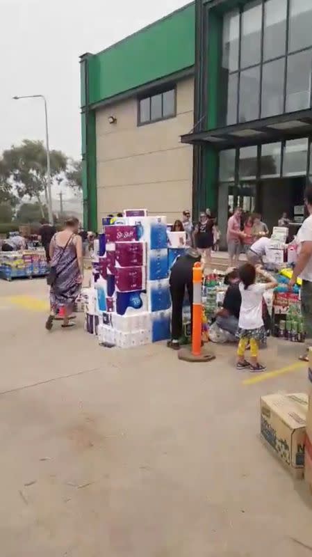 People bring goods for the firefighters and all other people affected by bushfires at a donation drop off point in Mitchell, near Canberra