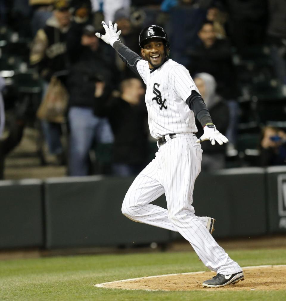 Chicago White Sox's Alexei Ramirez looks back at Marcus Semien after Semien reached first on a throwing error by Boston Red Sox shortstop Xander Bogaerts, allowing Ramirez to score the willing run during the ninth inning of a baseball game Tuesday, April 15, 2014, in Chicago. Chicago won 2-1.(AP Photo/Charles Rex Arbogast)
