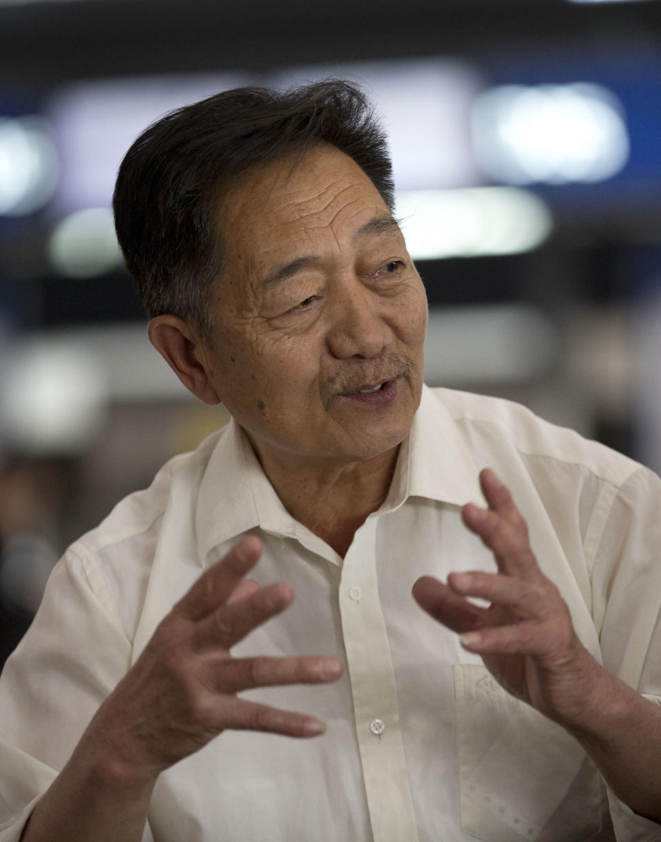 In this April 10, 2014 photo, Yue Caifei, 65, a retired engineer from Tianjin, China speaks before he sets off on a 15-day group tour of the U.S. at the Beijing Capital International Airport in Beijing, China. At airports across Asia and around the world, Flight 370 and its 239 passengers and crew, now lost for more than a month, are topics of avid speculation and sometimes anxiety. Passengers typically remain confident about the safety of air travel, but some are distressed by the disappearance, which - given the number of people involved - is unprecedented in aviation industry. Yue said “I’m not afraid at all. Flying is generally really safe and accidents are really, really rare. What’s the point of being afraid? We’re living a good life, our children are grown and it’s time for us to enjoy life. I’m going off to Hawaii and San Francisco and when I get back let’s go get a drink.” (AP Photo/Andy Wong)