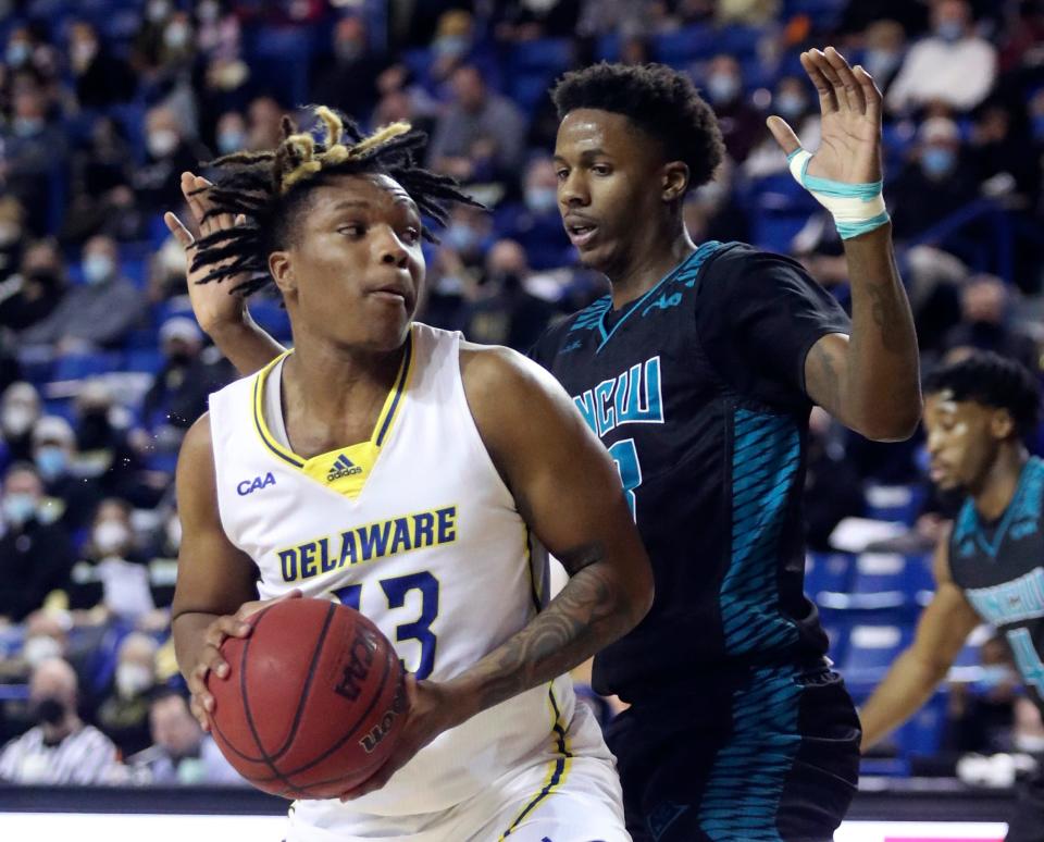 Delaware's Jyare Davis (left) is guarded by UNCW's Amari Kelly in the first half of UNCW's 69-62 win at the Bob Carpenter Center in Newark, Del., Saturday, Feb. 26, 2022.