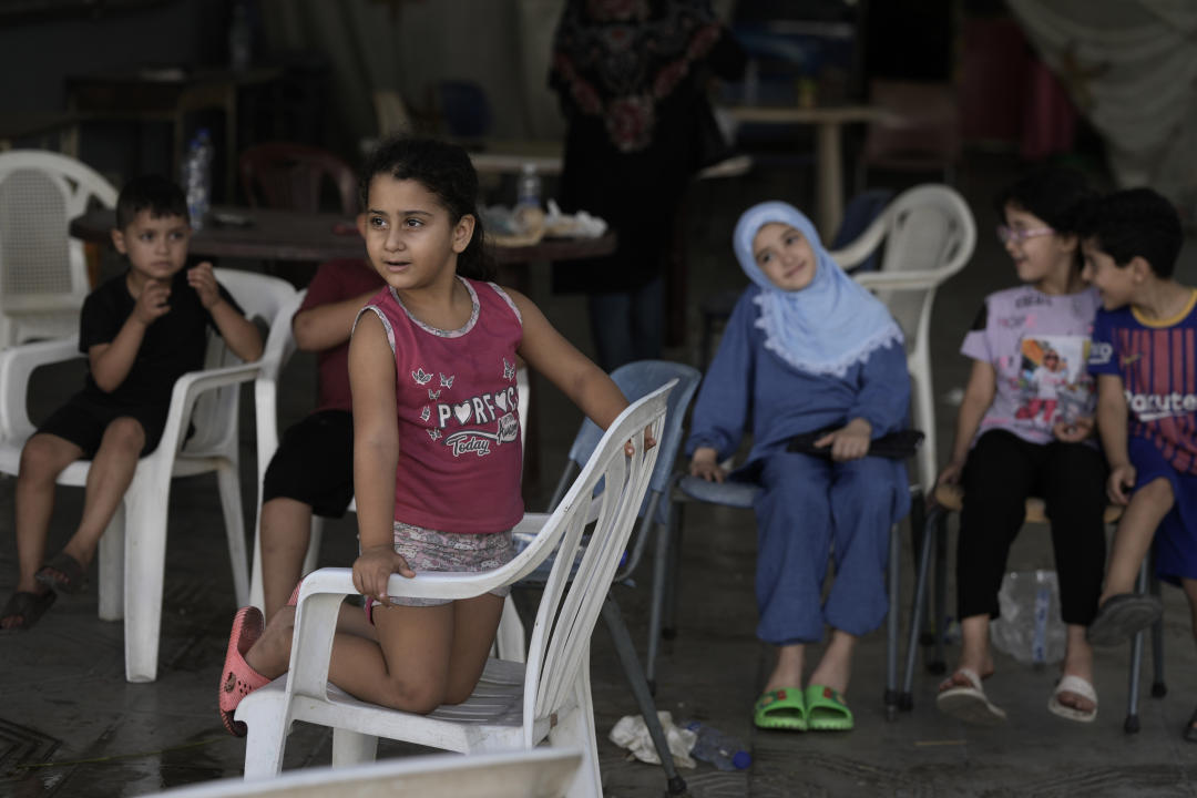 Children play as they take shelter in a school in Beirut, after fleeing the Israeli airstrikes in the southern Tyre district, Tuesday, Sept. 24, 2024. (AP Photo/Bilal Hussein)