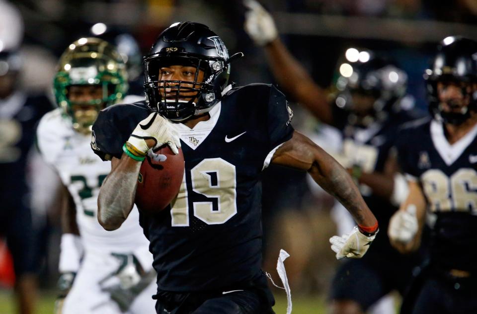 UCF Knights kick returner Mike Hughes (19) runs back the kick 94 yards for the go ahead scorer against the South Florida Bulls during the second half at Spectrum Stadium.