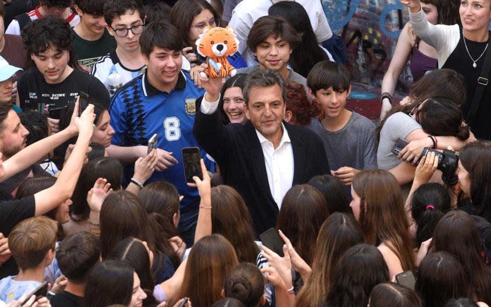 Mr Milei's opponent, Sergio Massa, holds a tiger doll during his closing campaign rally